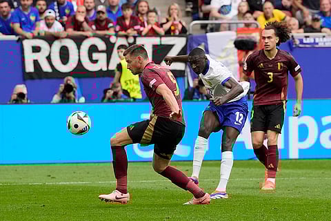 Randal Kolo Muani shoots at goal to cause Jan Vertonghen to score an own goal